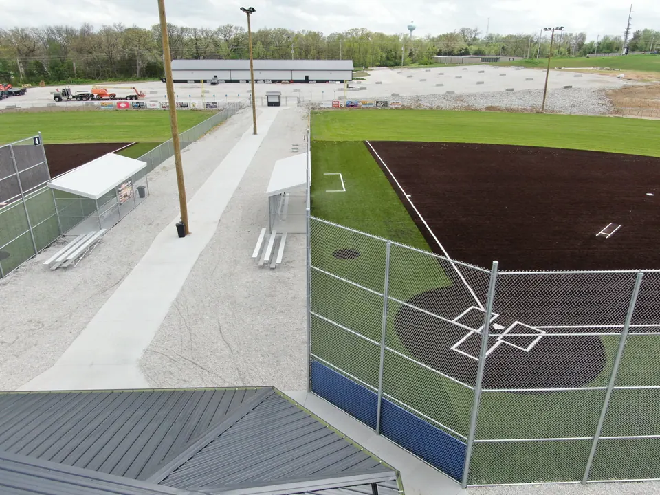 Chain link backstop and dugout fencing at a softball field